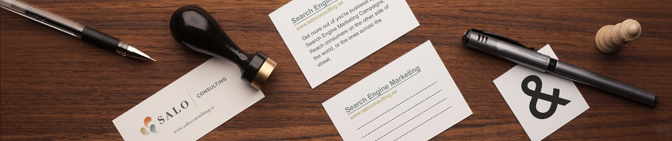 SALO consulting business card, note paper of search engine marketing headline with a stamp and pencil is laying on a brown wooden table.